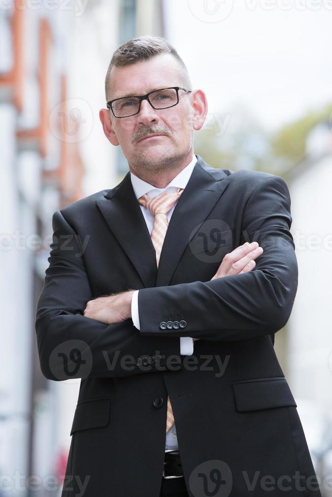 portrait of businessman standing in the street photo