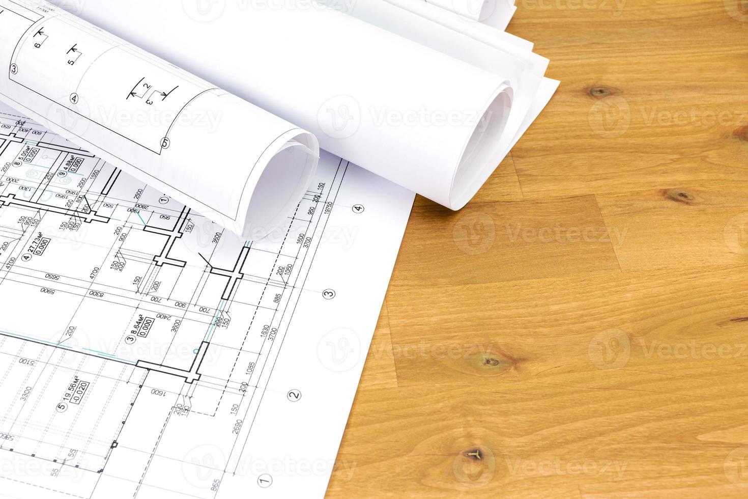 construction drawings on wooden desk photo