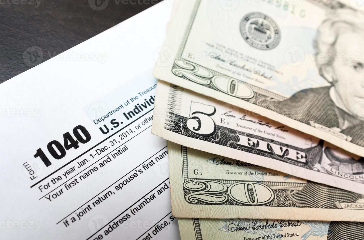 1040 Individual tax return form close up and dollar bils photo