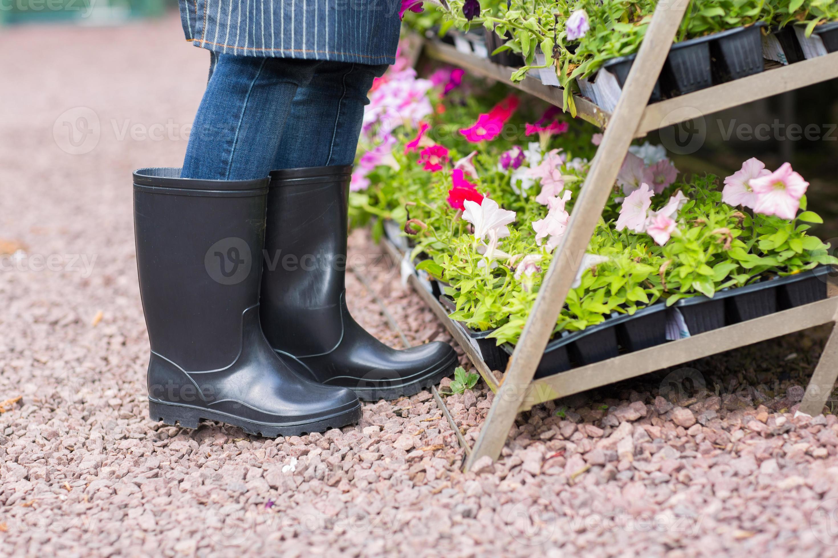 gardener wearing gumboots in nursery 861555 Stock Photo at Vecteezy