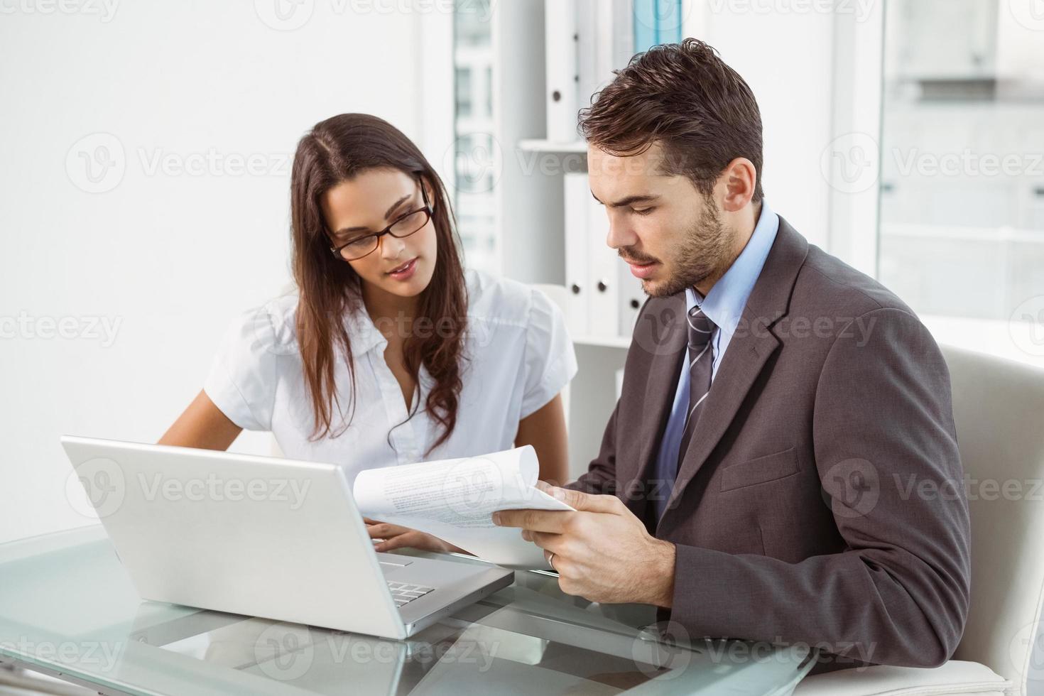 Business people using laptop in office photo