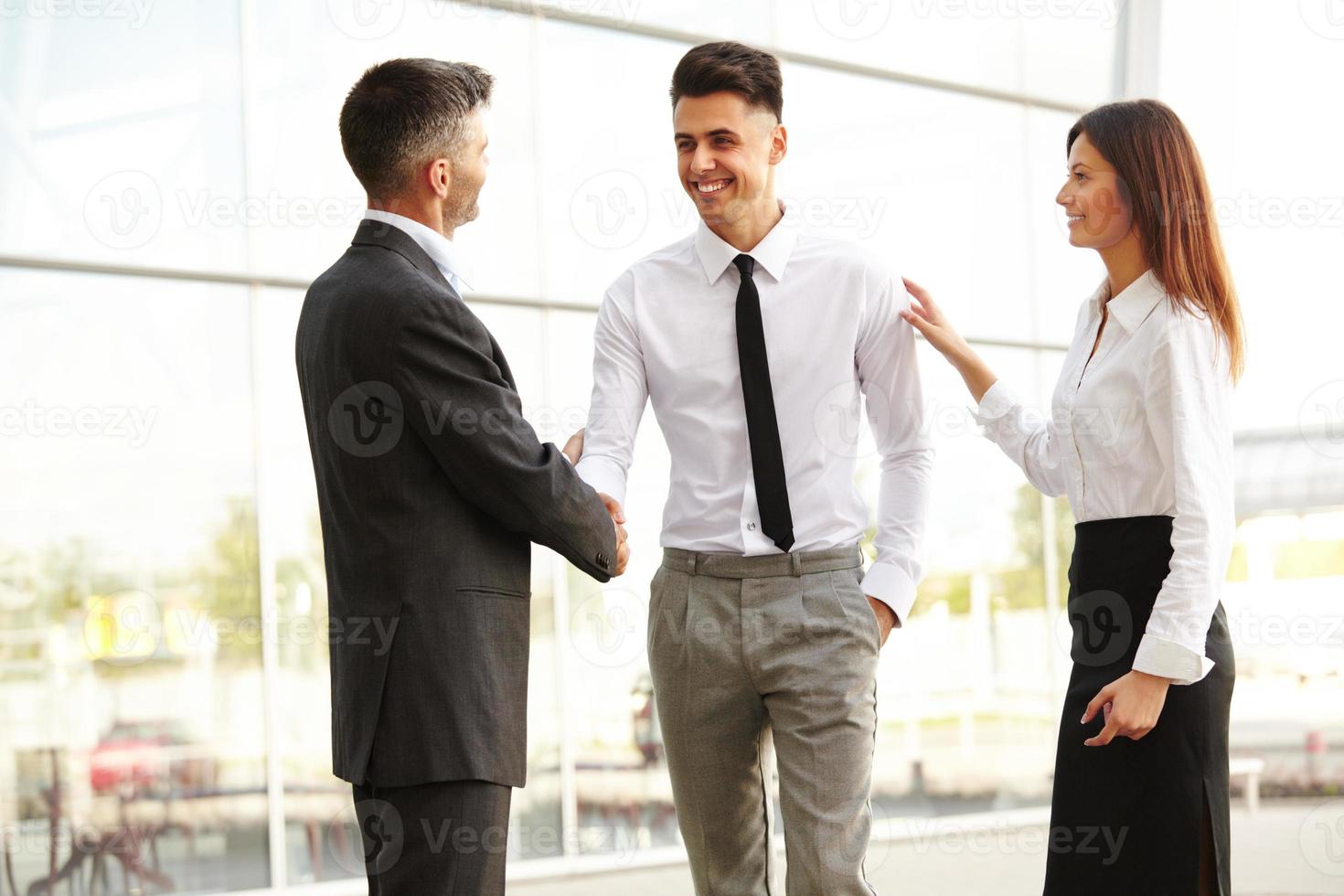 Business Team. People shake hands communicating with each other photo