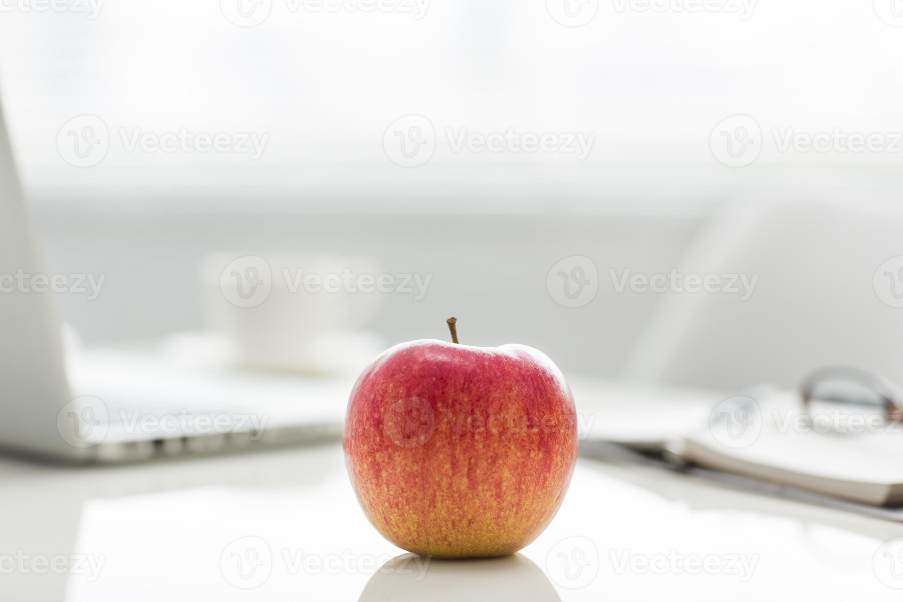 Apple on the desk 866474 Stock Photo at Vecteezy