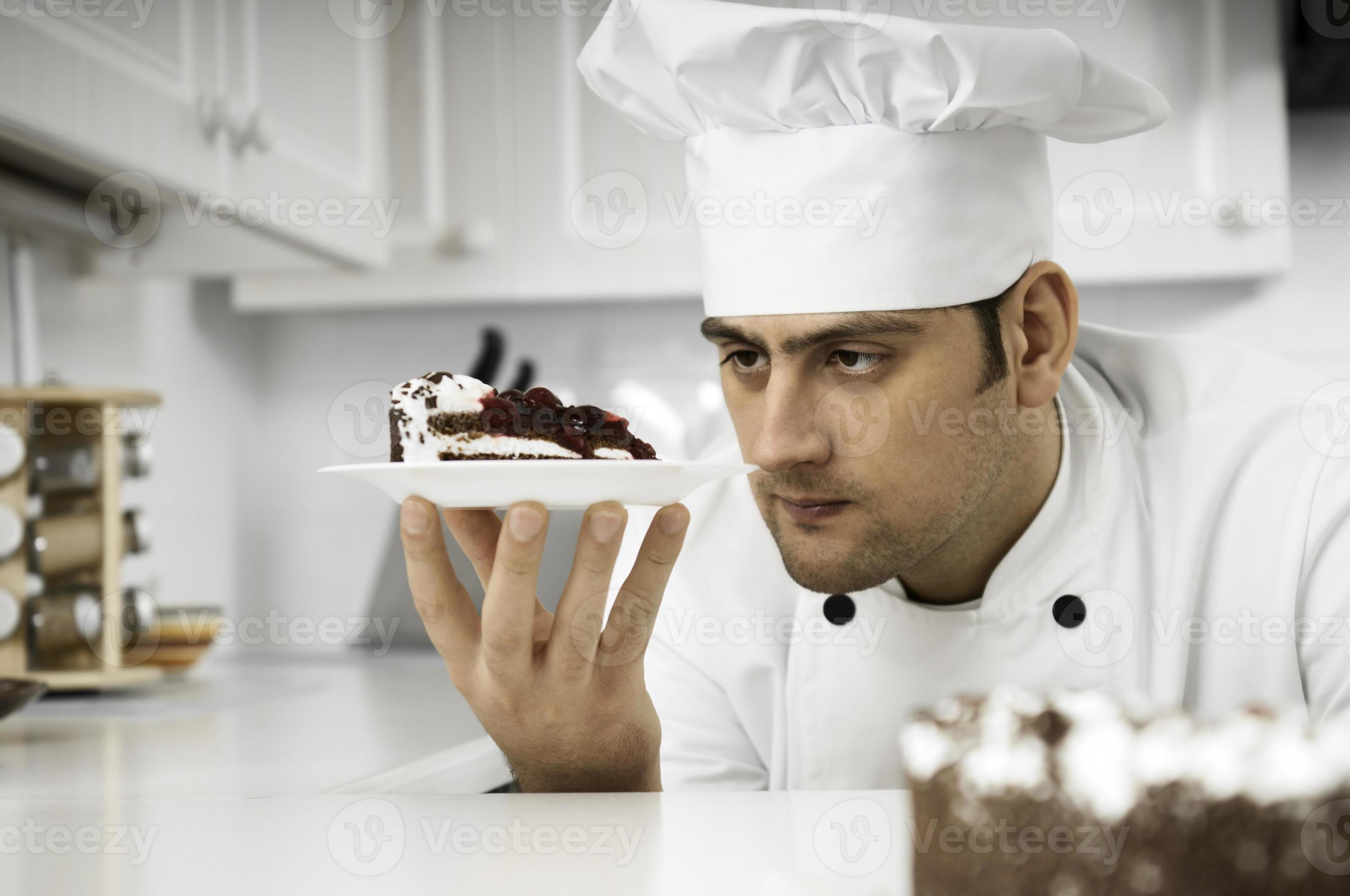 Chef closely examining dessert plate photo