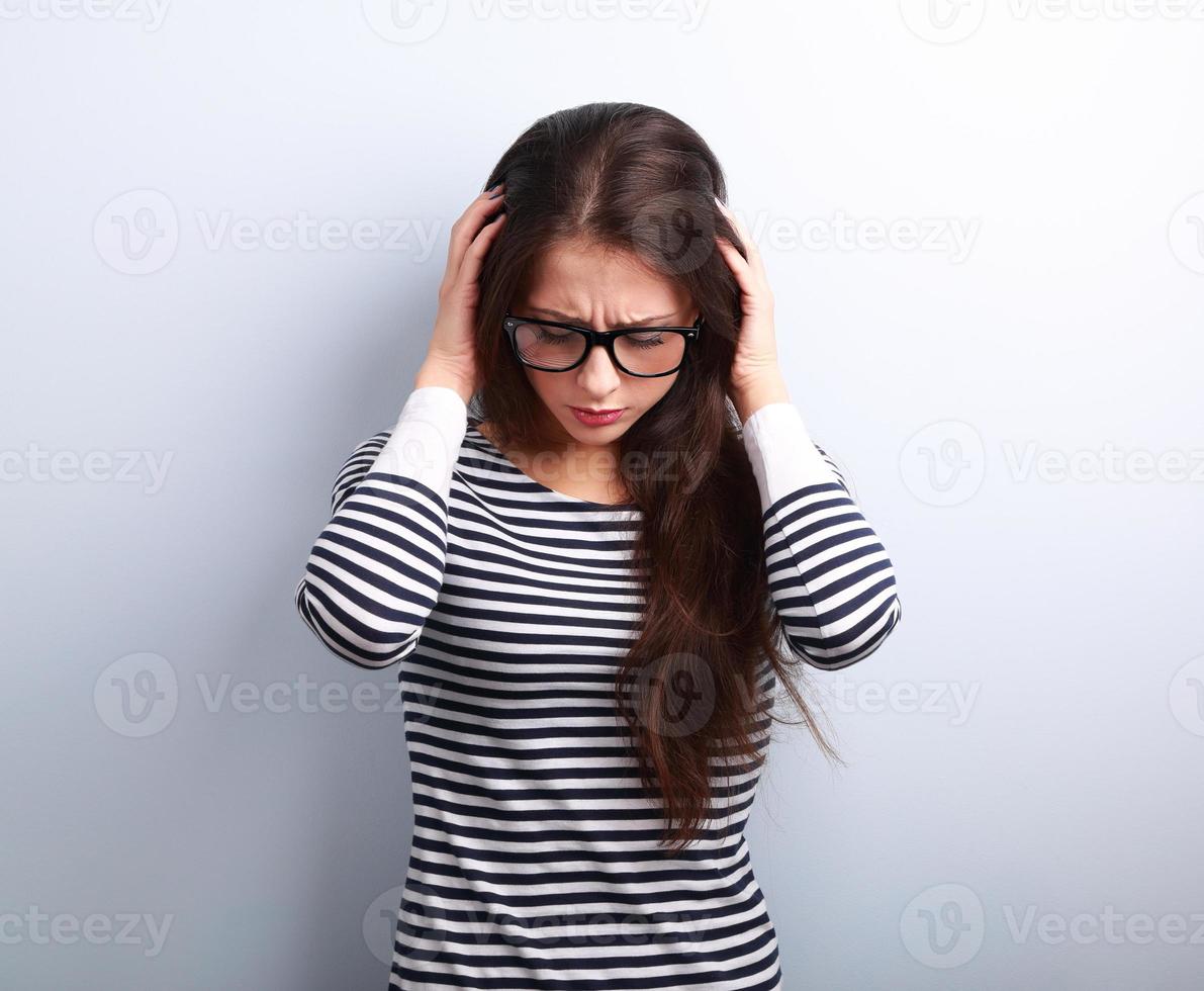 Business unhappy young woman with headache holding head the hand photo