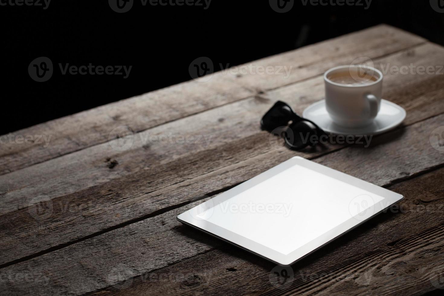 screen of digital tablet pc on wooden table photo