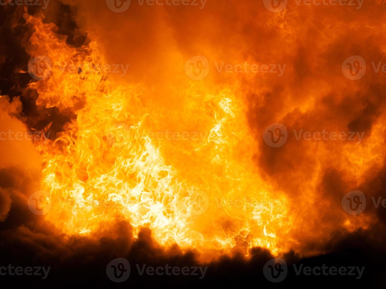 Burning fire flame on wooden house roof photo