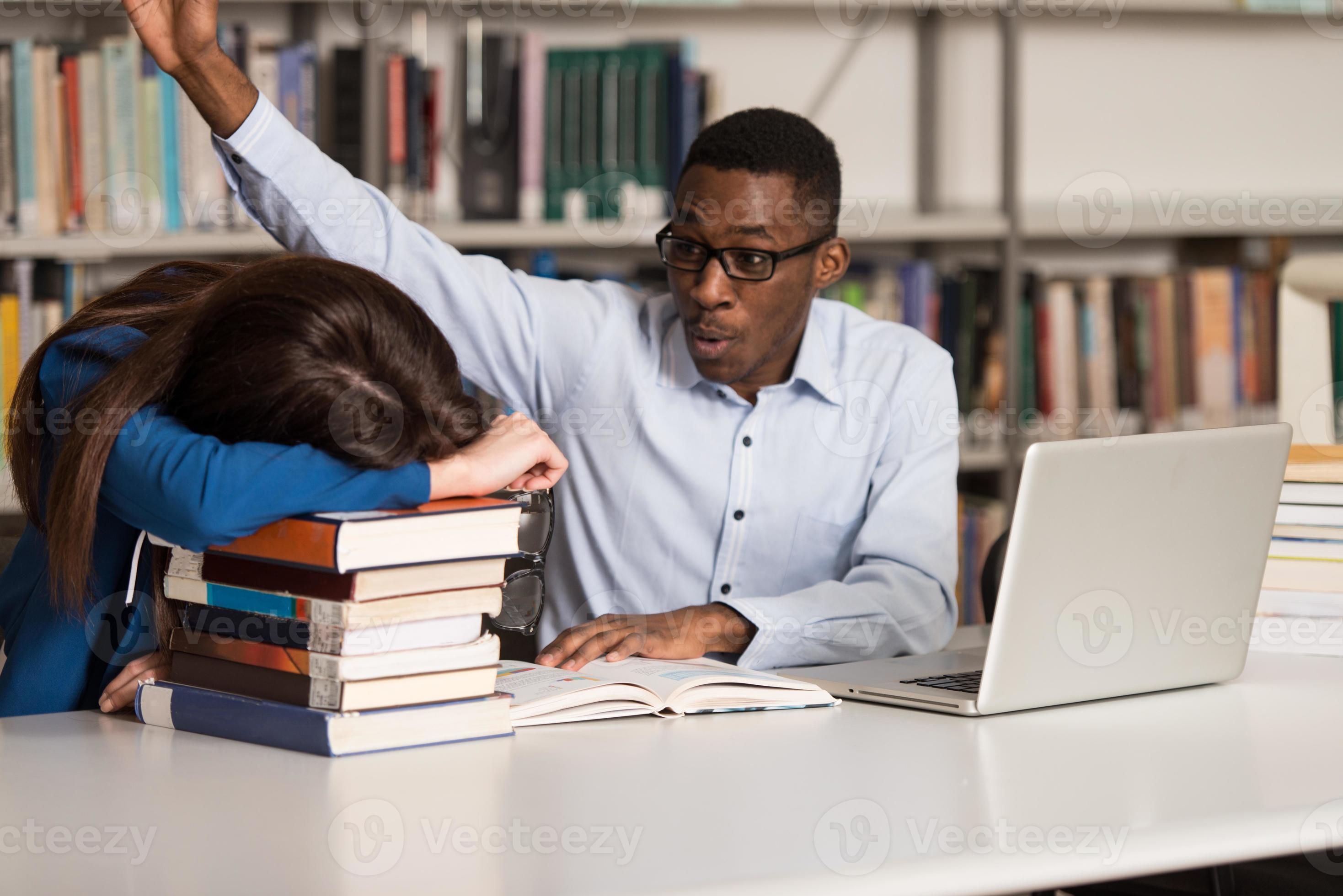 Male Student Trying To Waking Up A College 873337 Stock Photo at Vecteezy