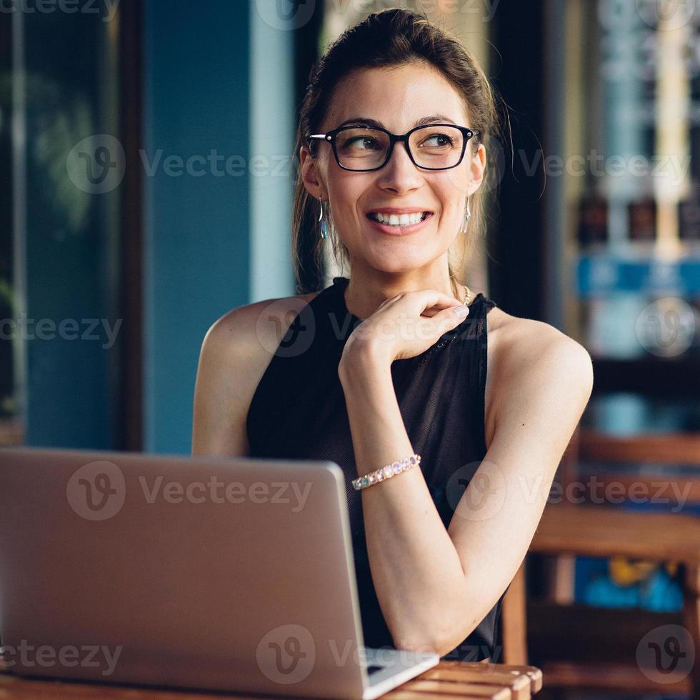 Attractive business woman working at his laptop photo