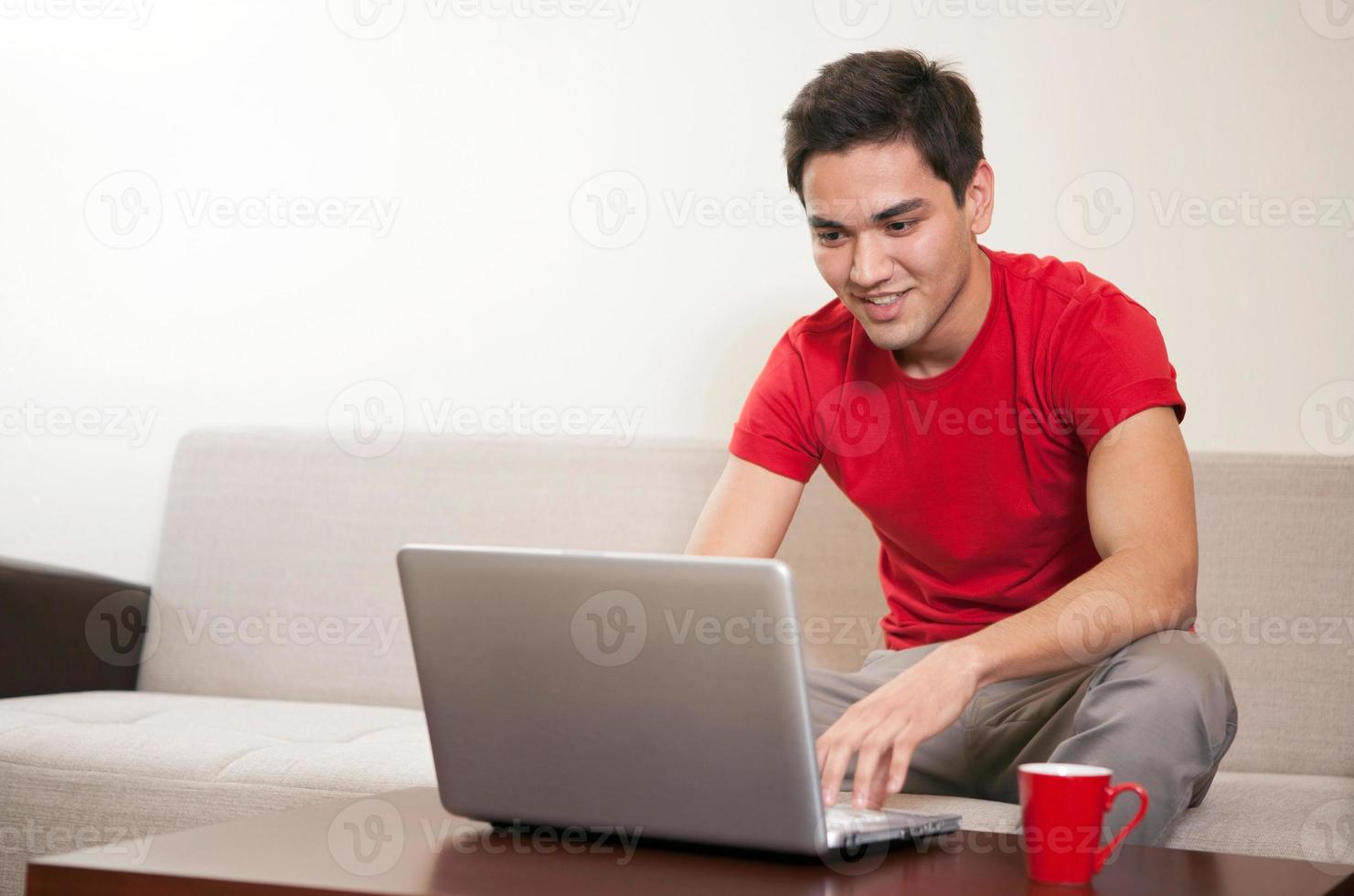 Young man working on a laptop photo