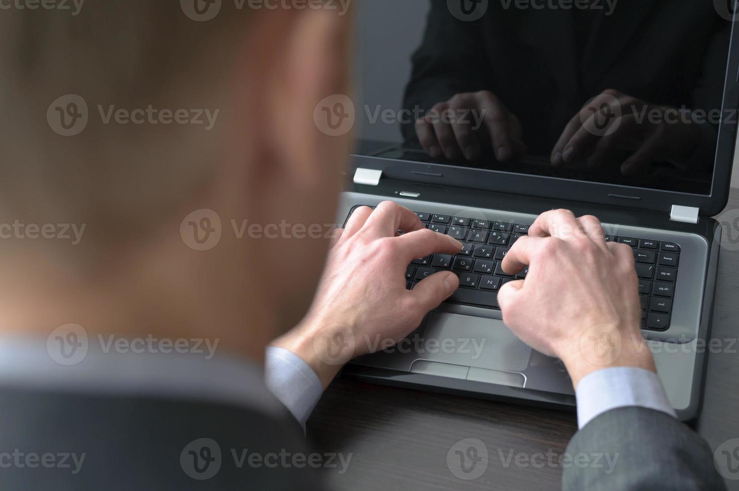 Businessman hands on laptop keyboard photo