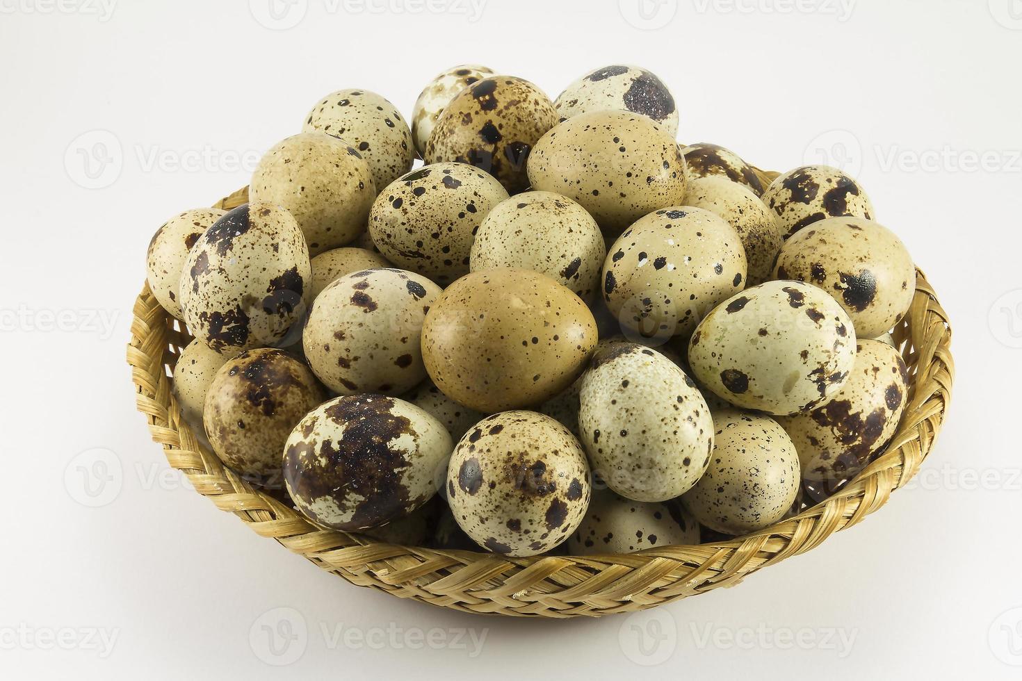 Quail eggs in a wicker oval shape photo
