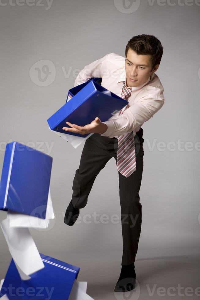 Young caucasian businessman droping a stack of binders failure 884999