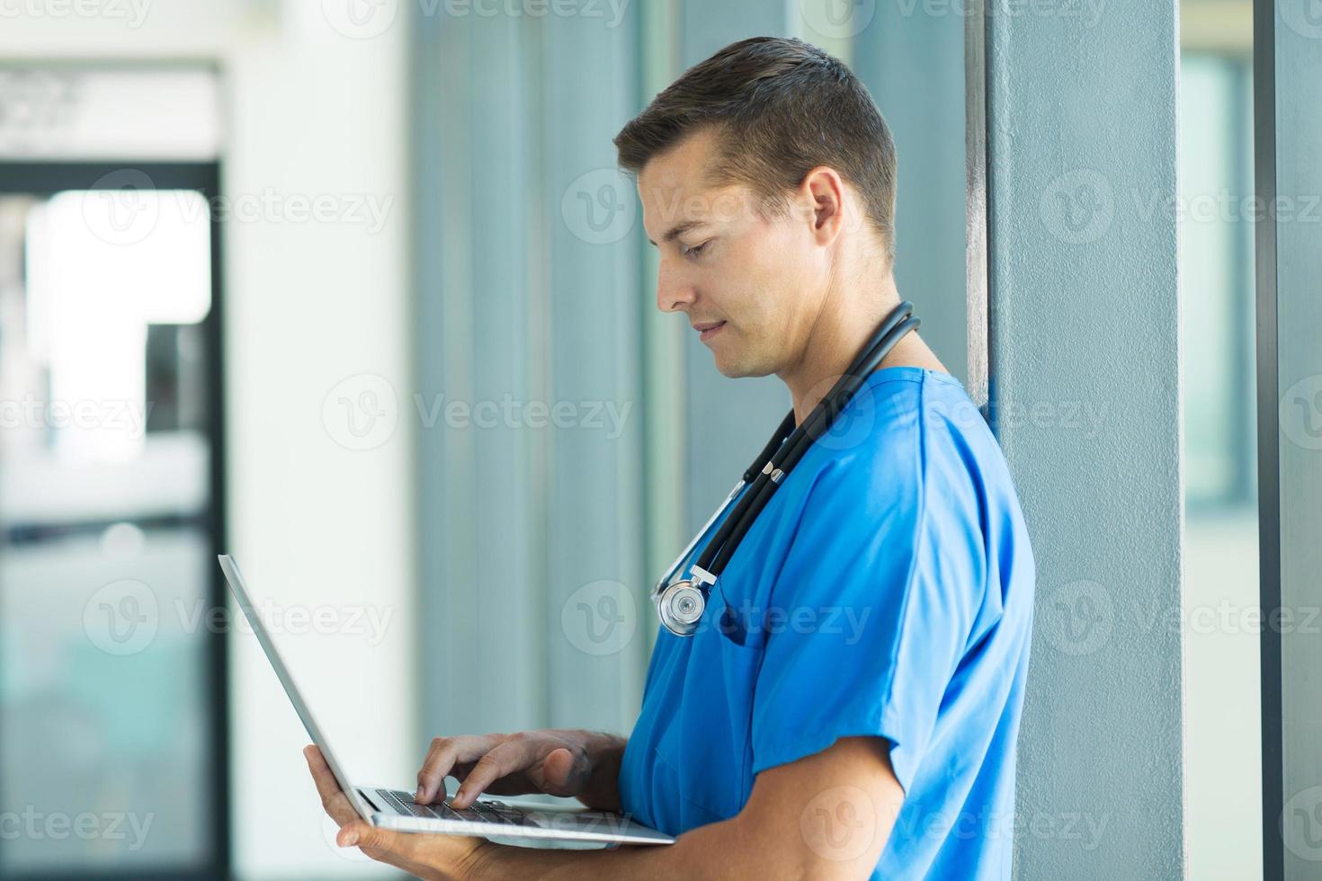 medical worker working on laptop computer photo