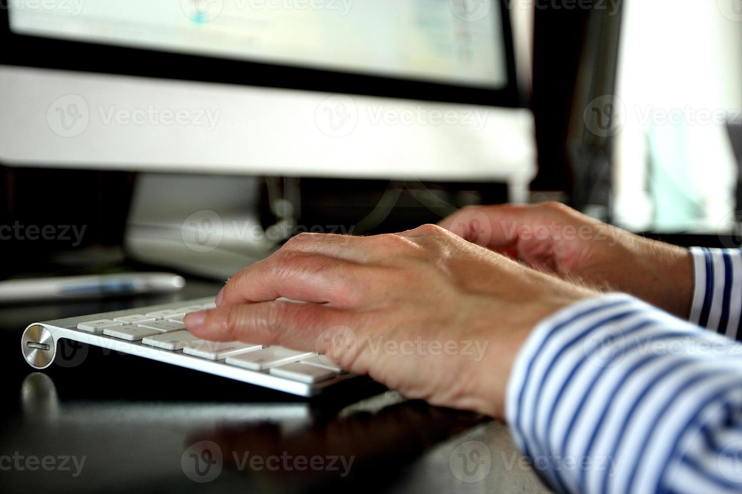 Man is typing on keyboard photo