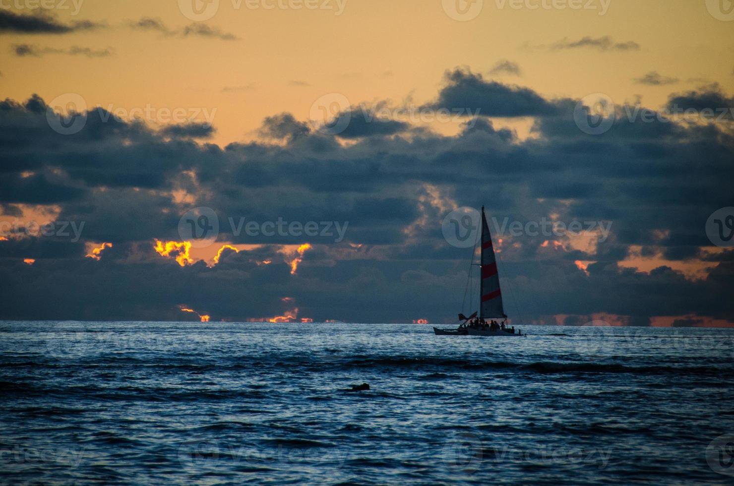 Sailboat silhouette at sunset photo