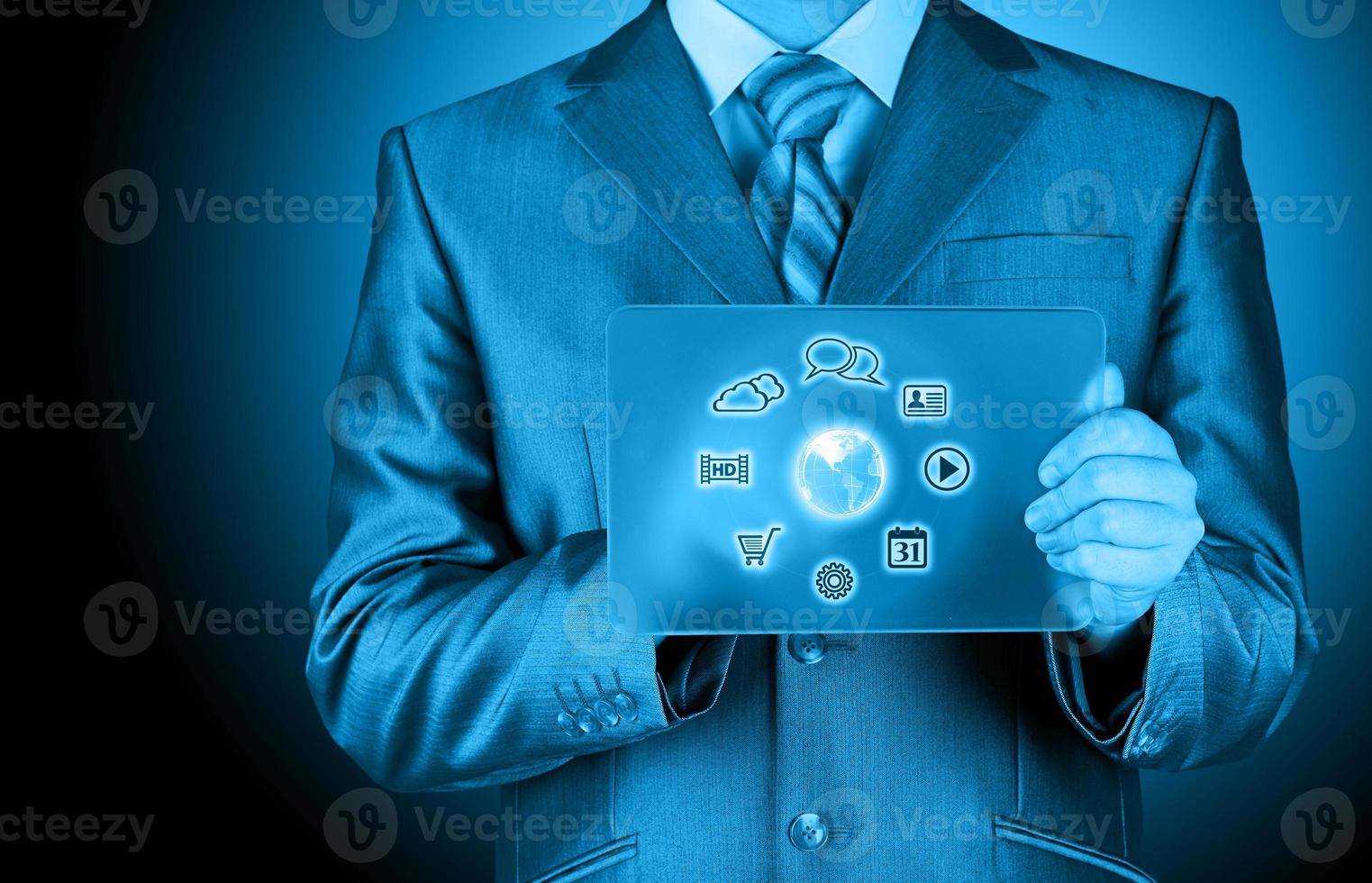 Businessman pressing icon  glass tablet photo