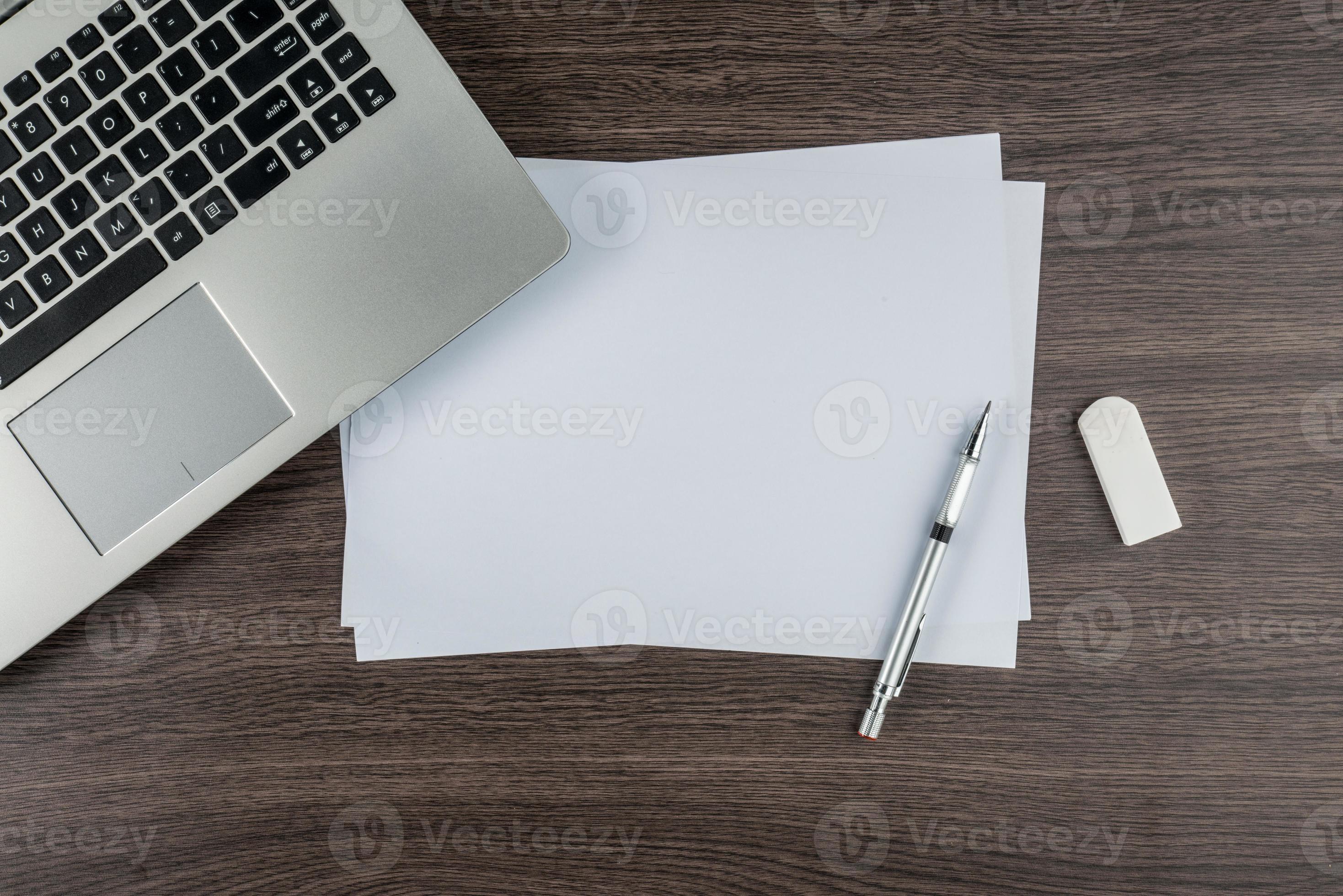 Laptop, paper pen and Eraser on work desk 893005 Stock Photo at Vecteezy