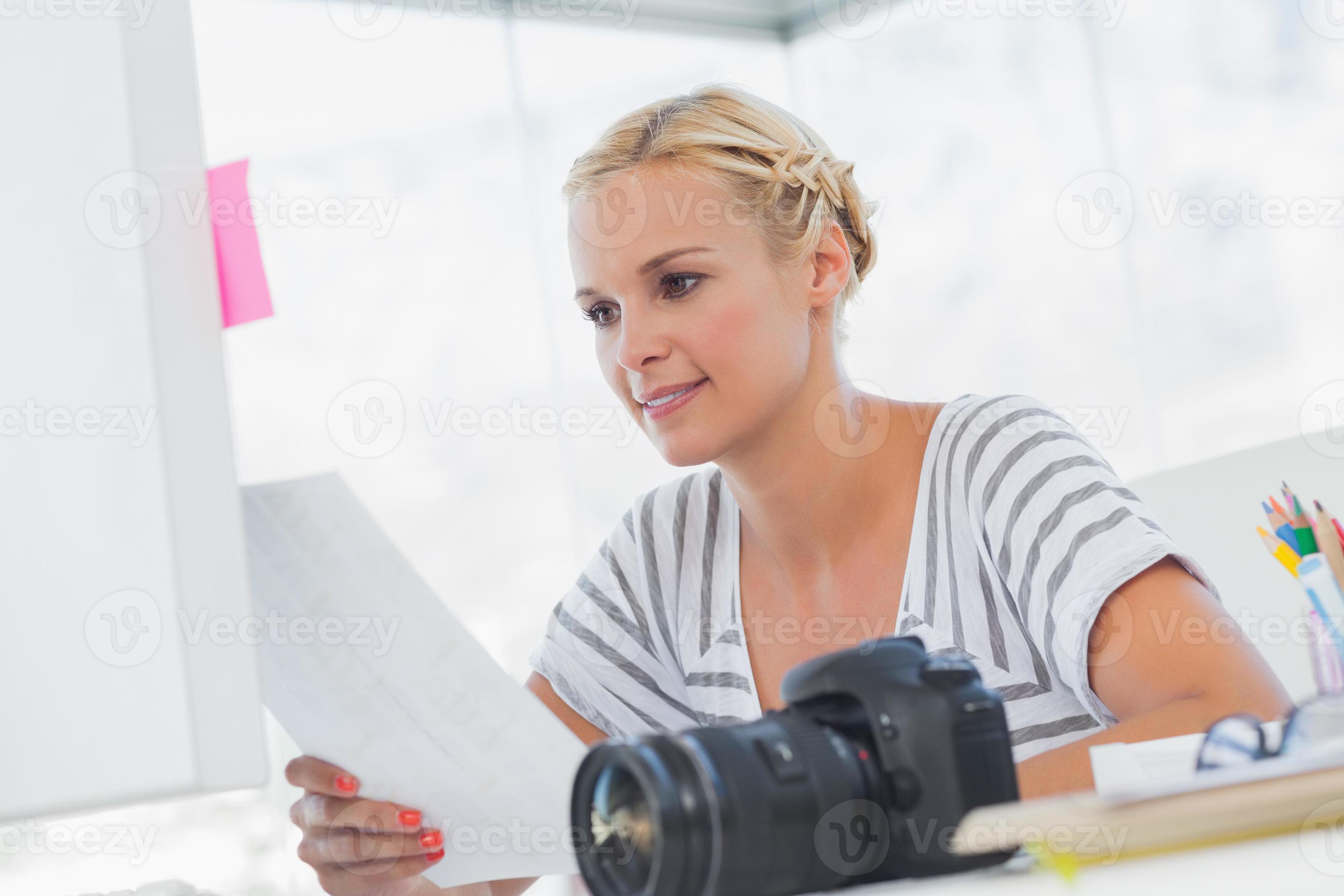 Pretty photo editor looking at a contact sheet