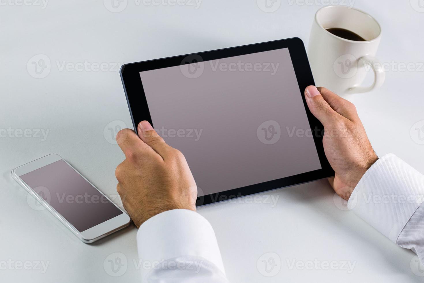 Businessman using his tablet pc photo