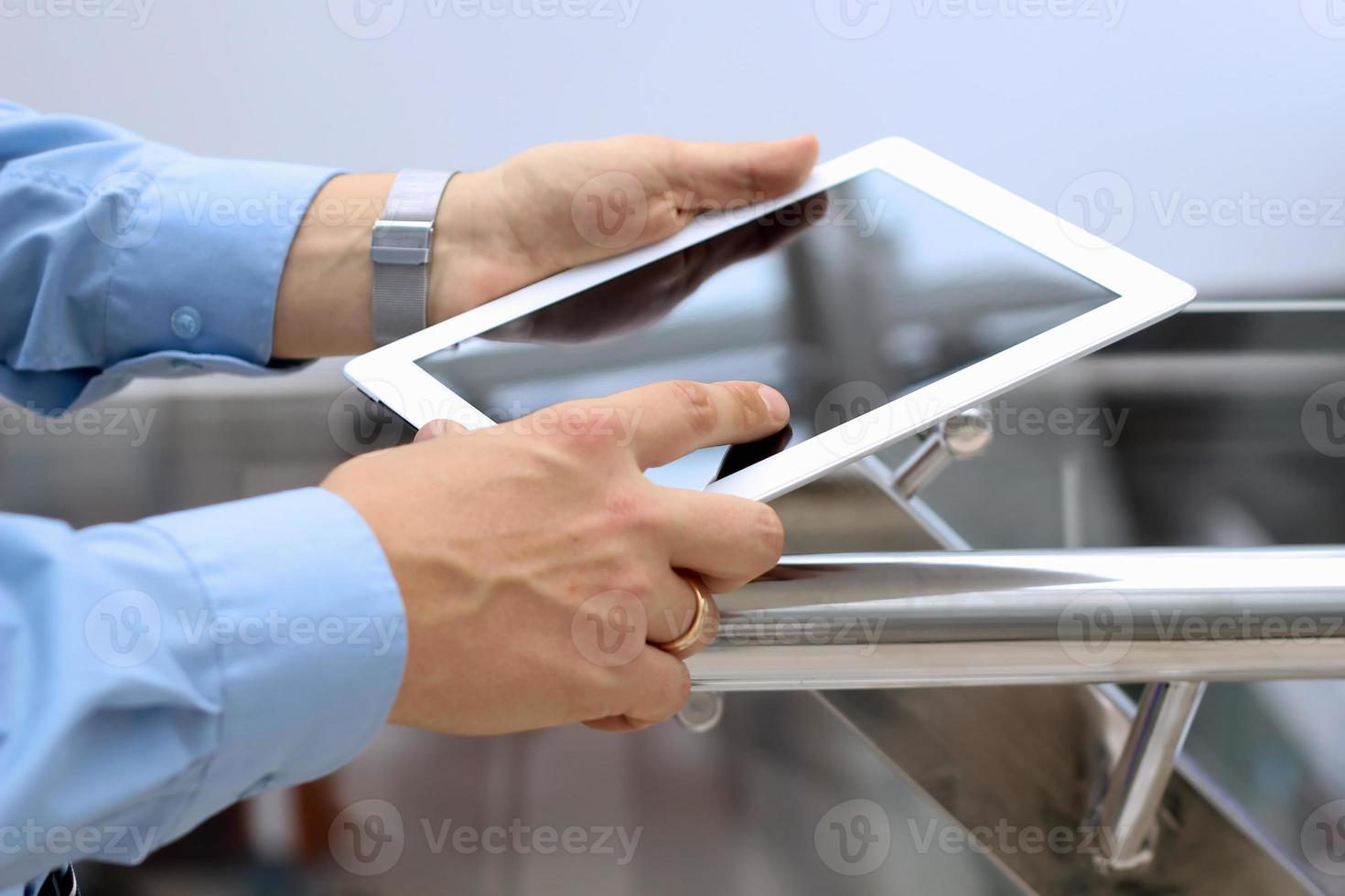 Businessman holding  and using the digital tablet. photo