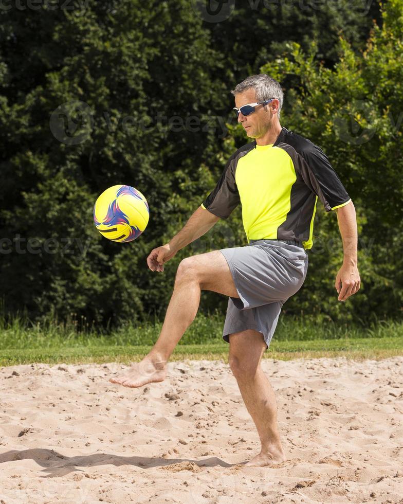 athlete playing beach soccer photo
