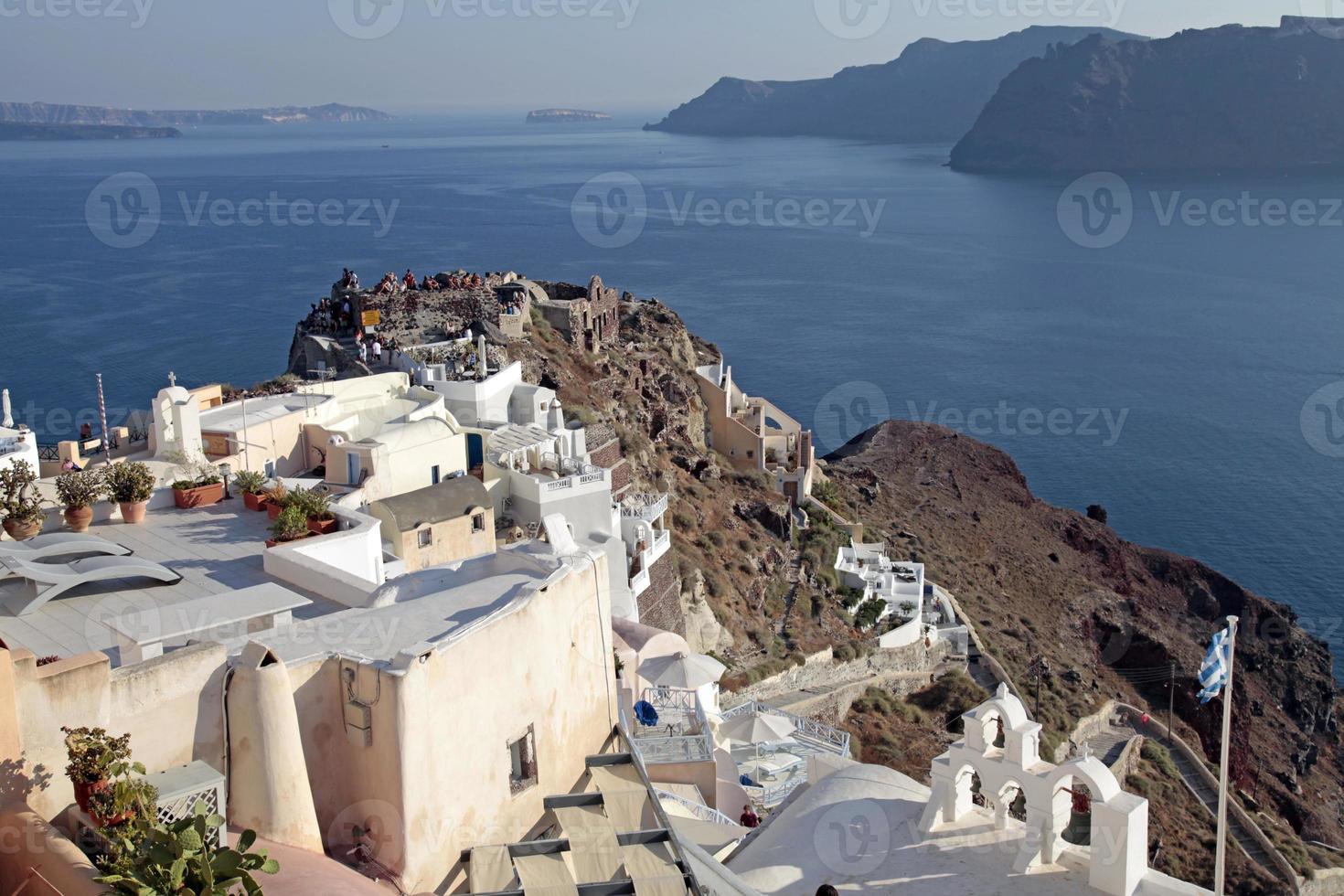 View of Oia town and old castle, Santorini, Greece. photo