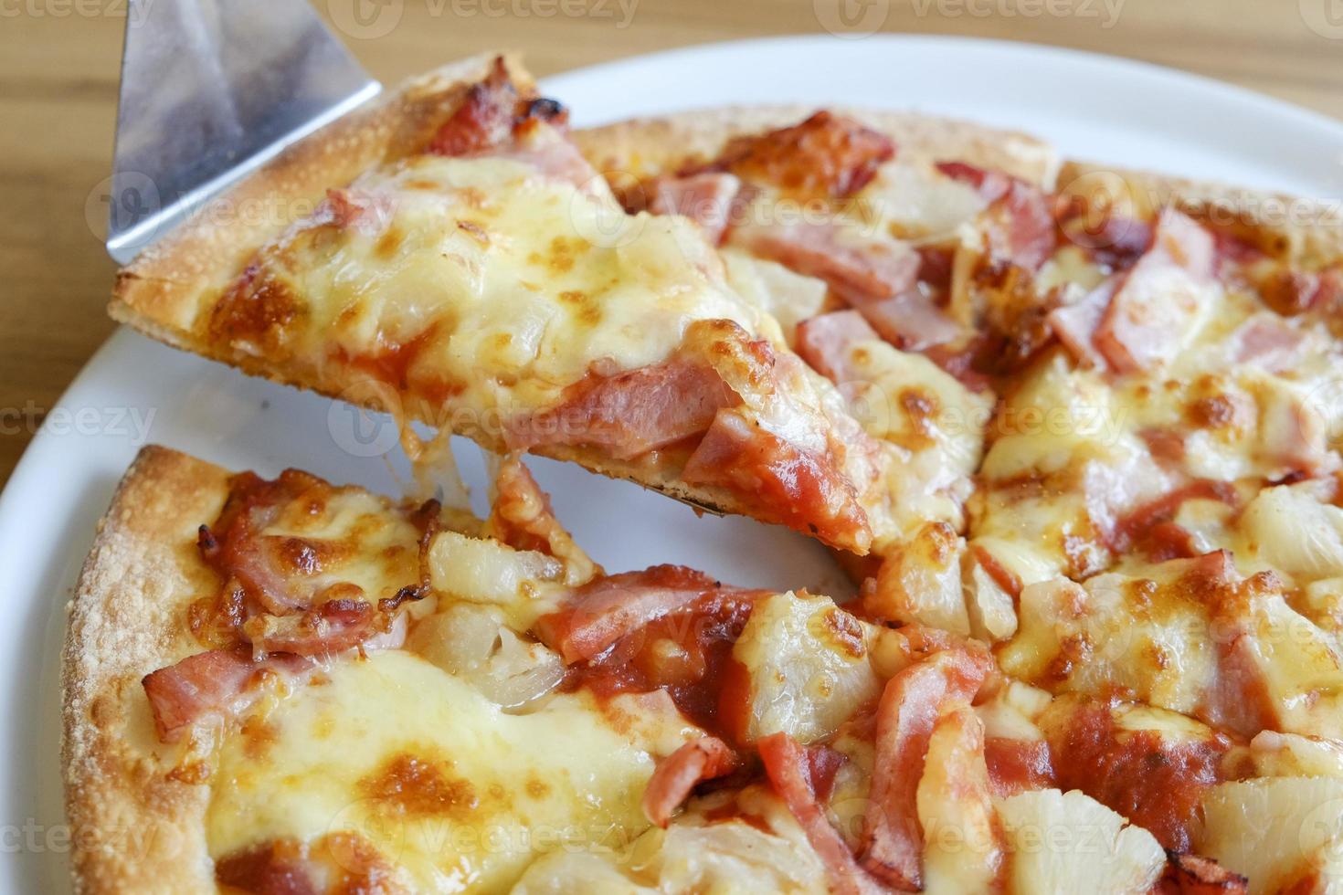 delicious hawaiian rustic style pizza made with fresh pineapples photo