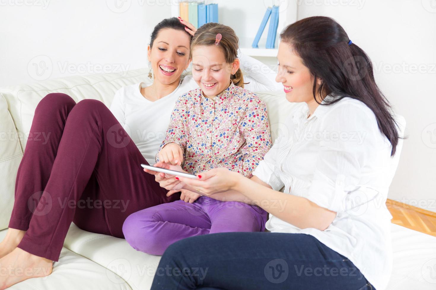 Two women and girls with digital tablet photo