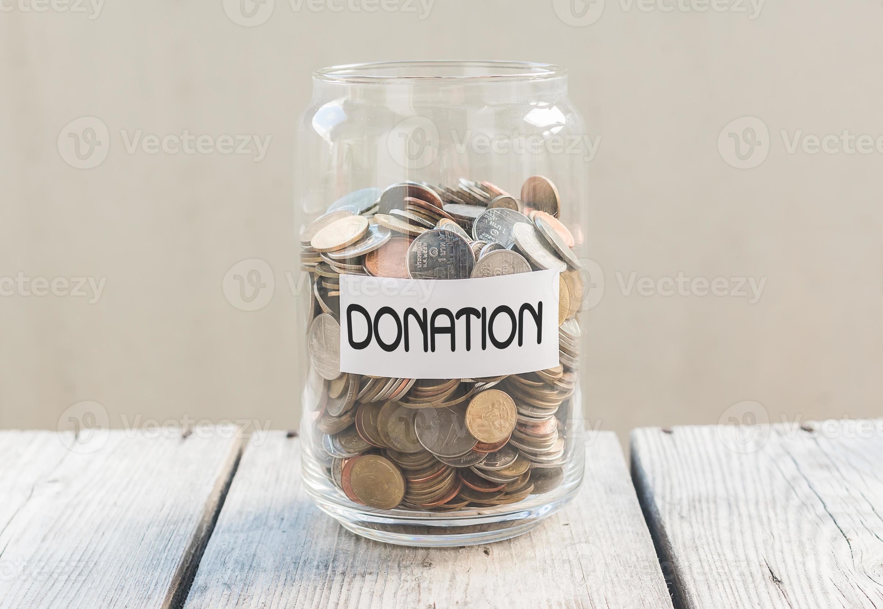 Money jar with coins on wood table 902886 Stock Photo at Vecteezy