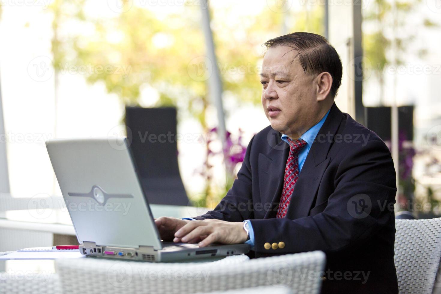 Asian businessman using laptop PC photo