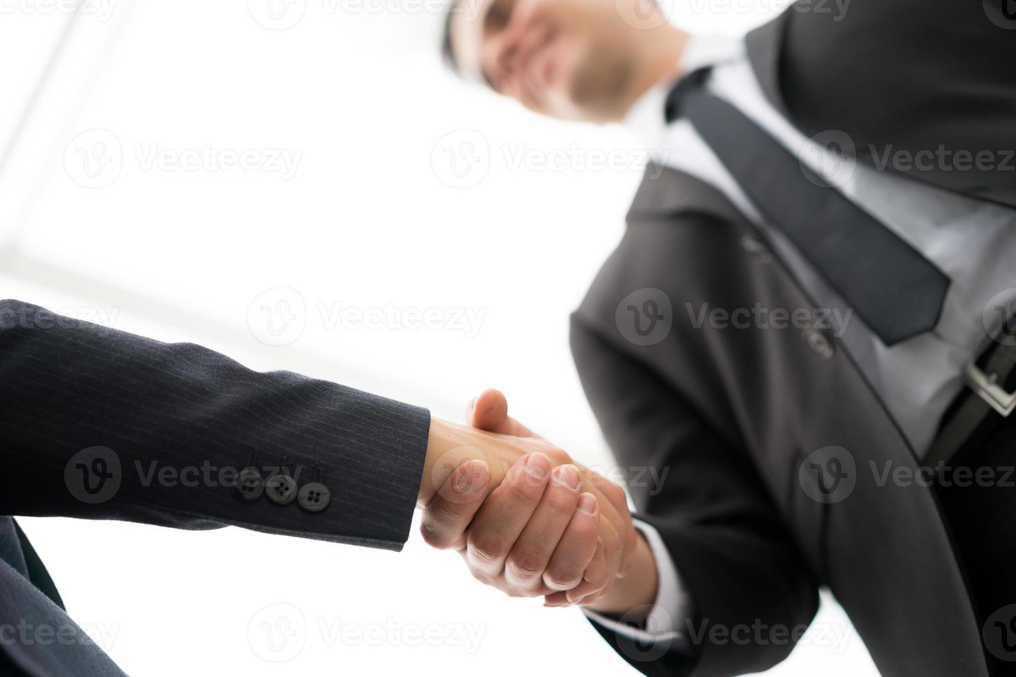 Business man and woman handshake at office photo