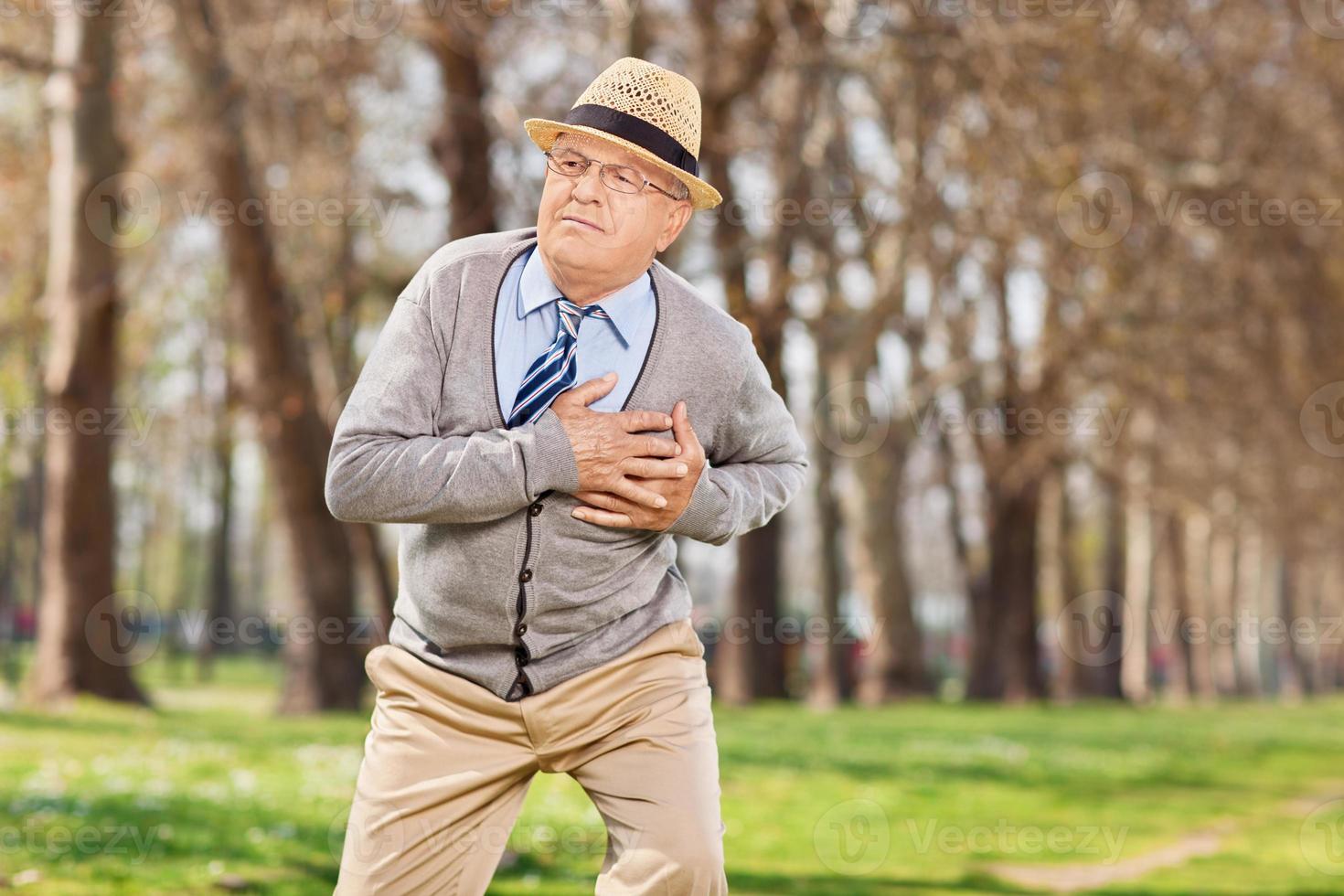 Senior teniendo un paro cardíaco en el parque foto