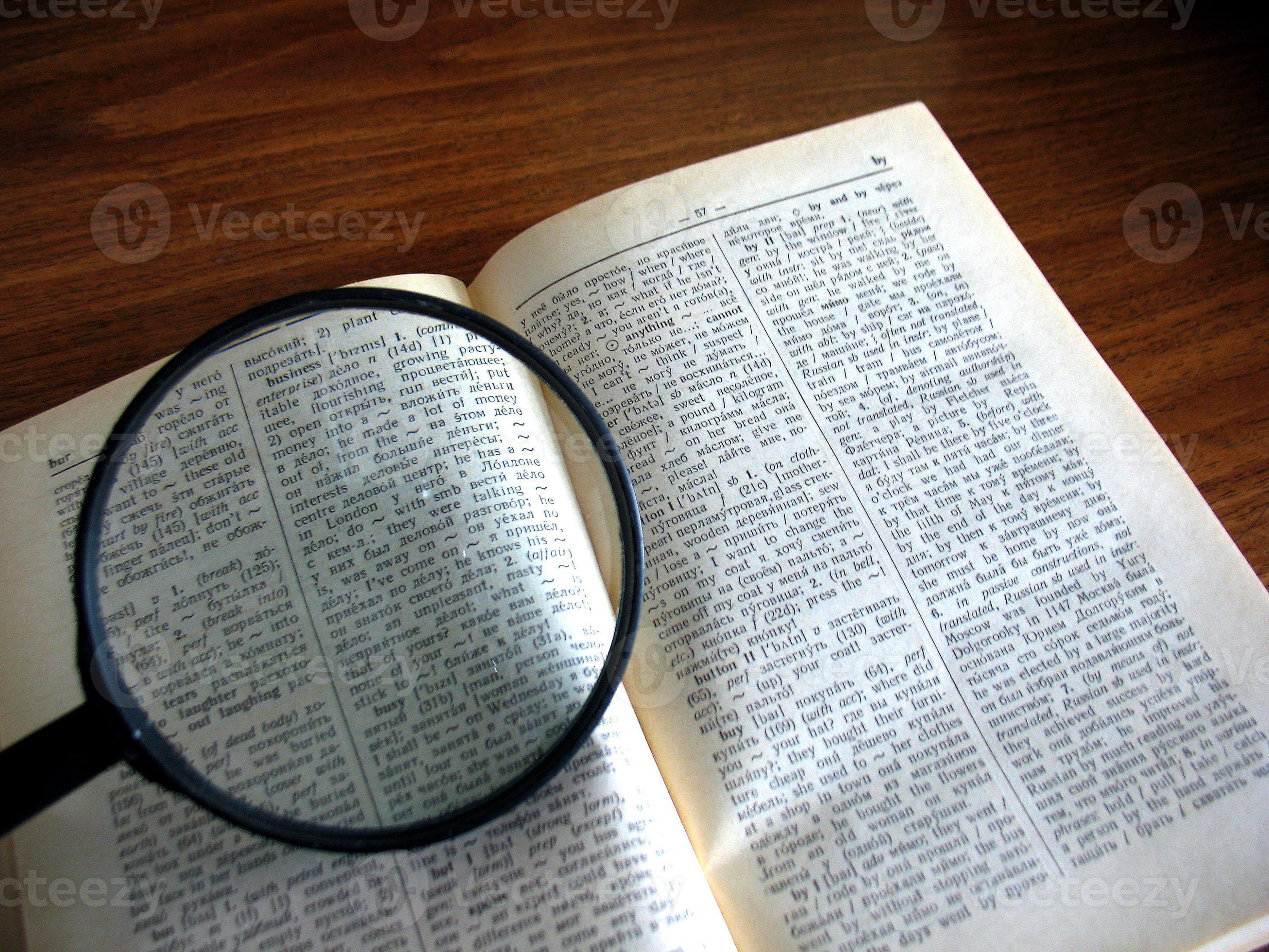 book and magnifying glass 904235 Stock Photo at Vecteezy
