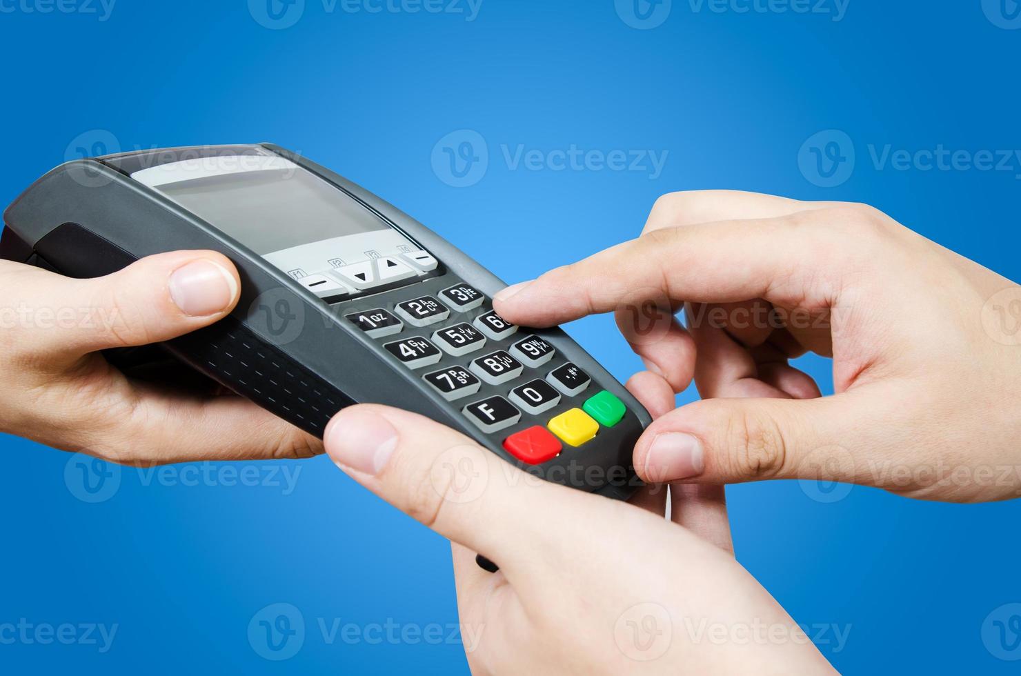 Hand with credit card swipe through terminal for sale photo