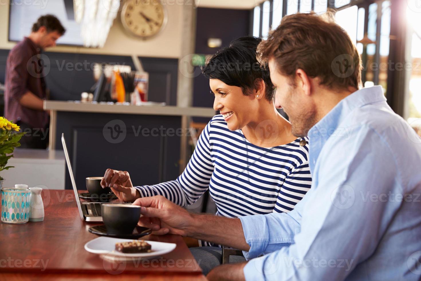 Man and woman meeting over coffee in a restaurant photo