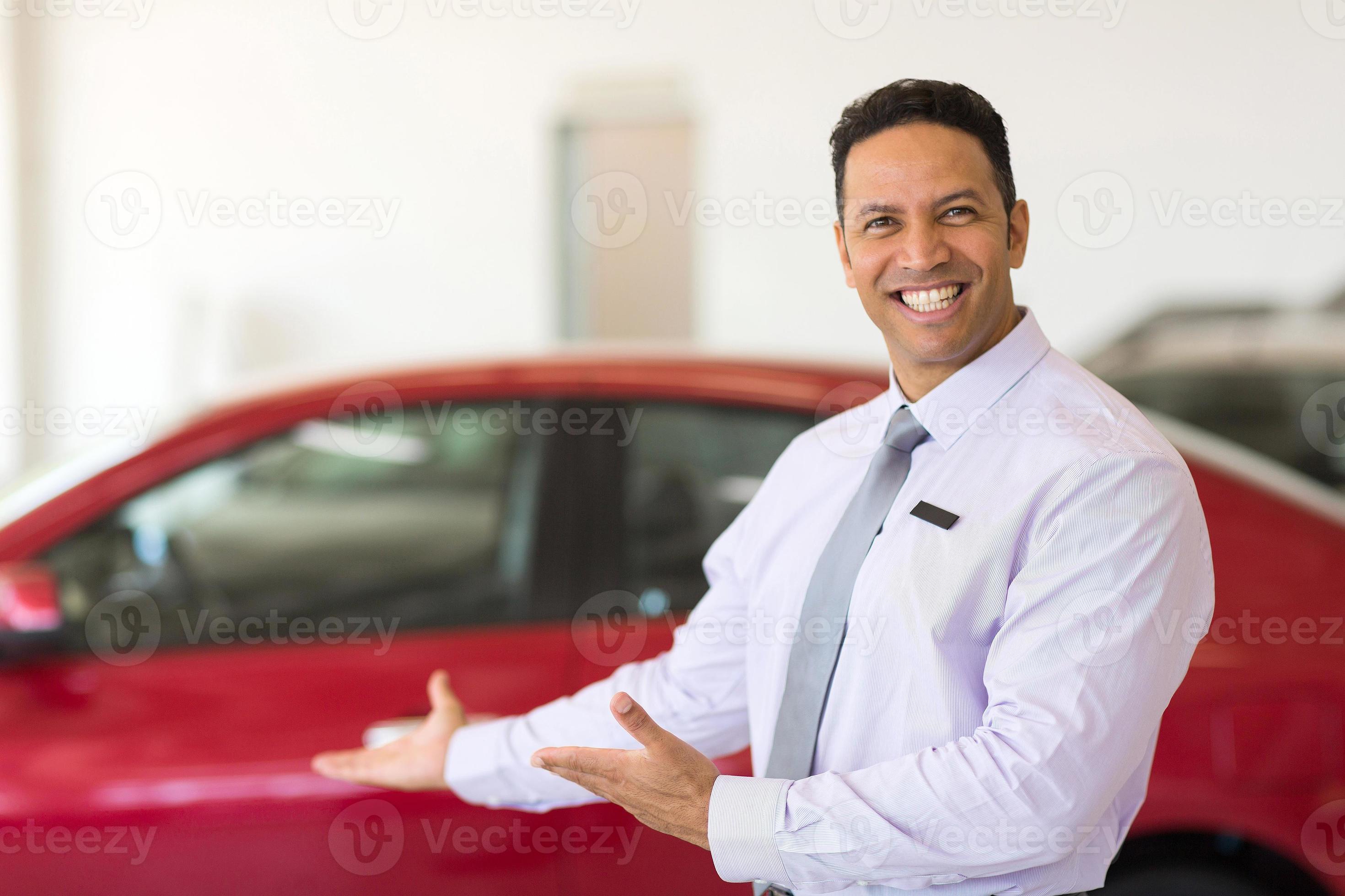 vendedor de vehículos presentando autos nuevos foto