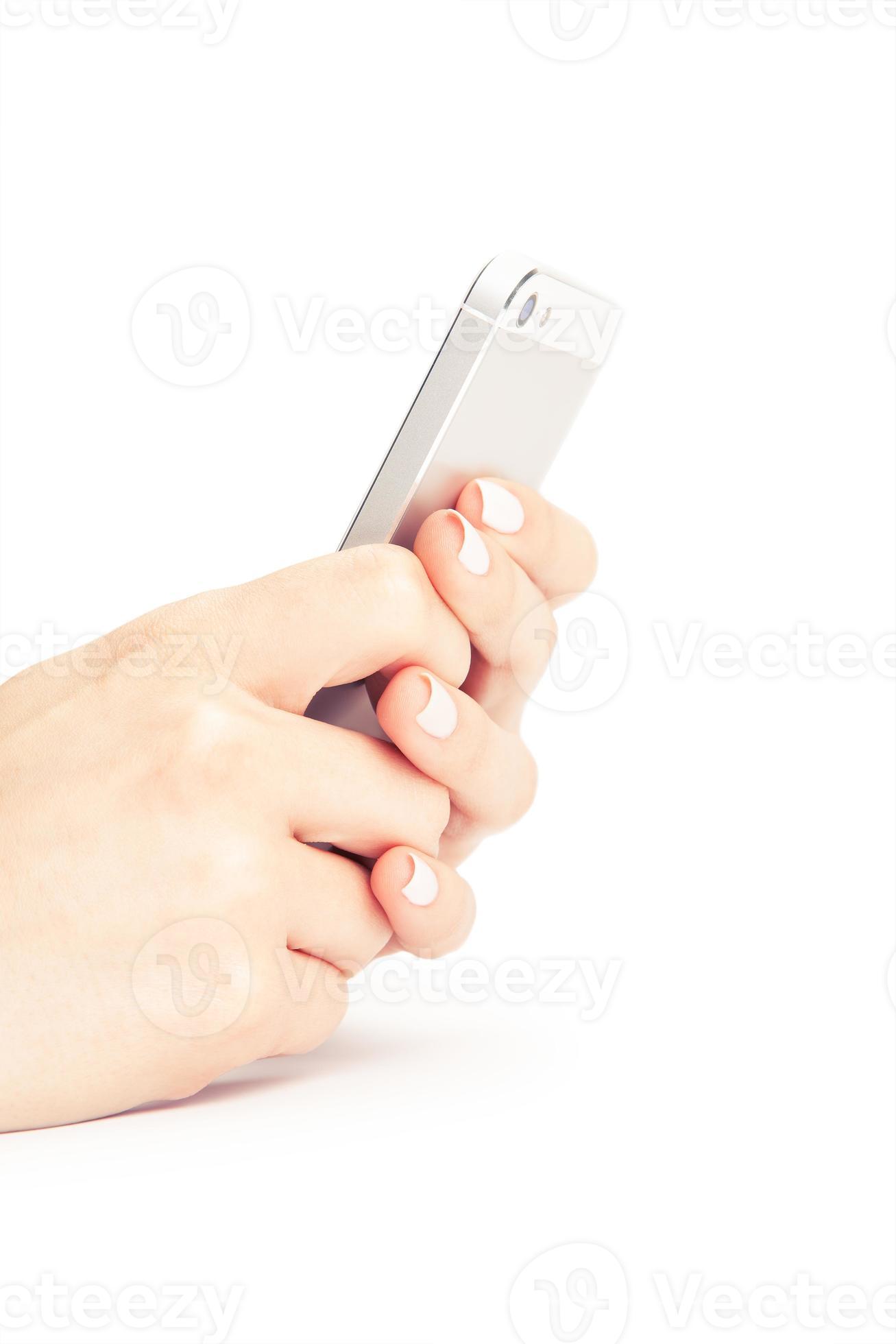 Mano que sostiene el teléfono inteligente blanco con pantalla en blanco sobre blanco centrico foto
