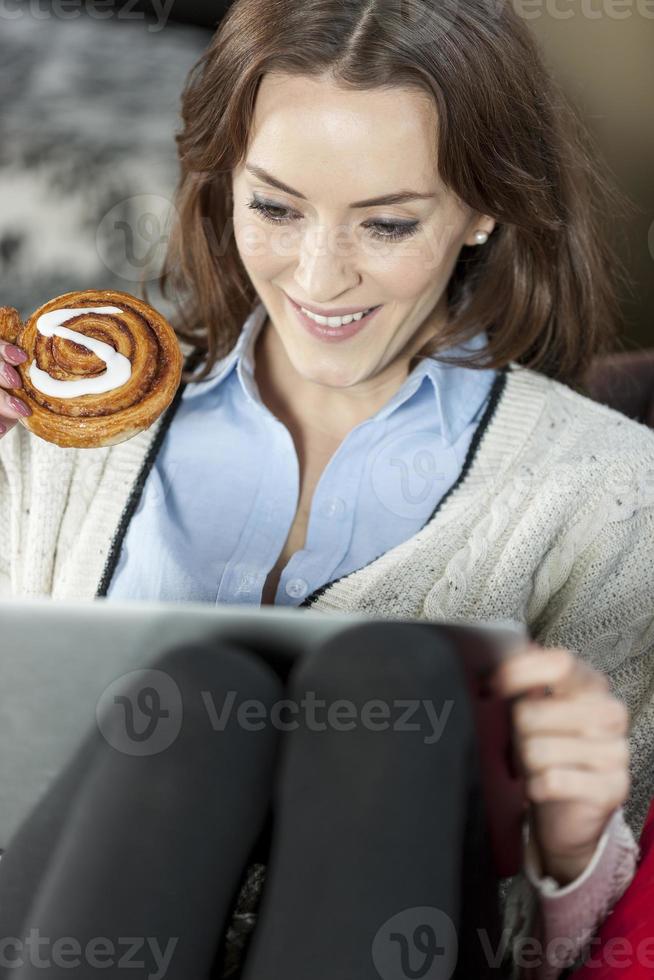 Woman using laptop relaxing photo