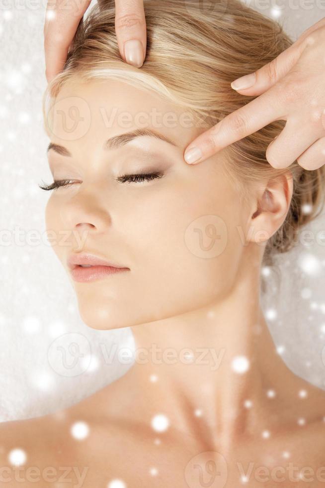 beautiful woman getting face or head massage photo