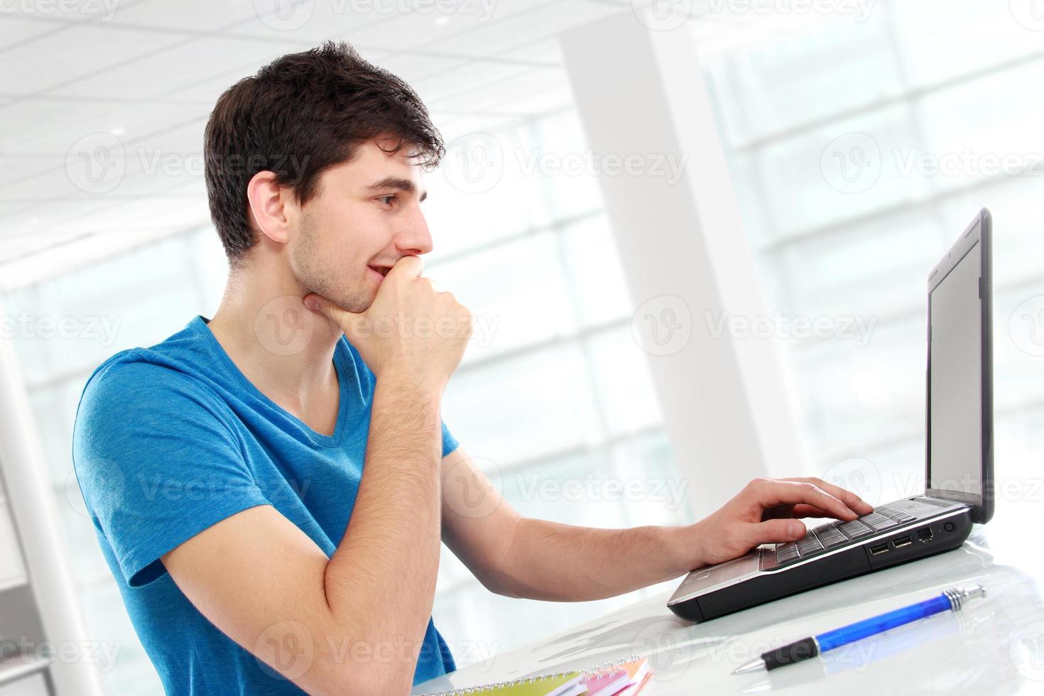 college student using his laptop photo