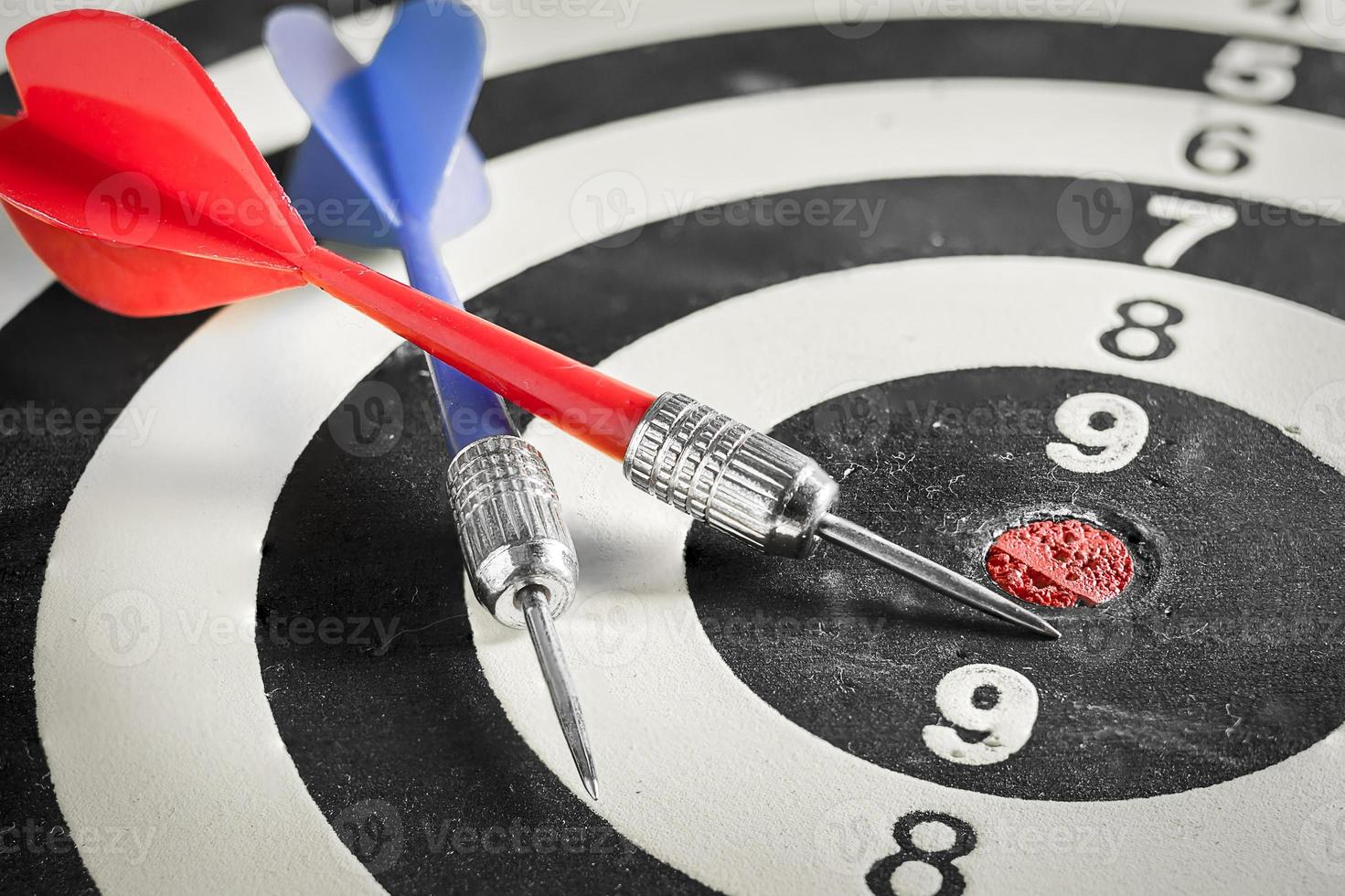 Red and blue dart arrow on dartboard photo
