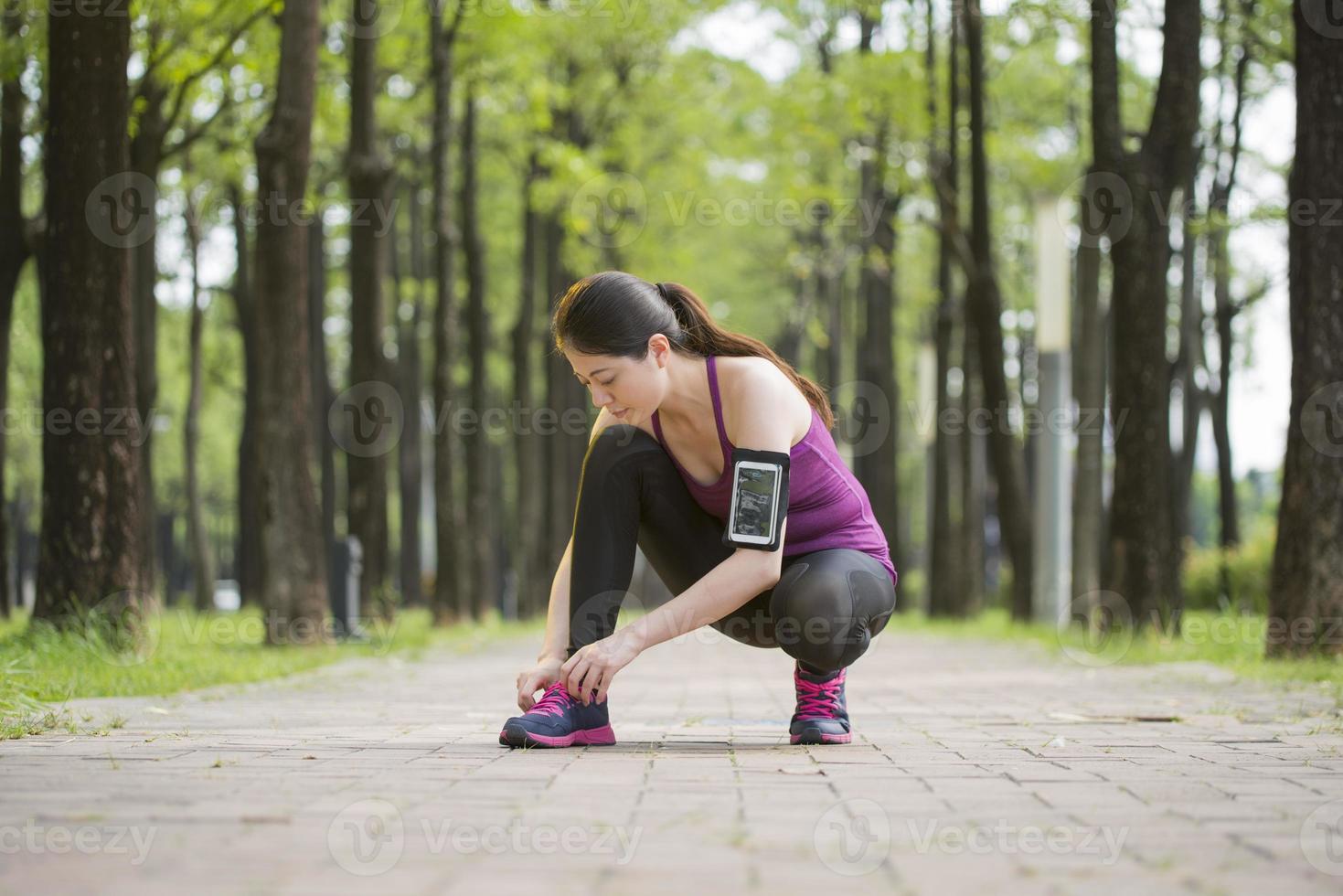 Asian young woman runner tying shoelaces healthy lifestyle photo