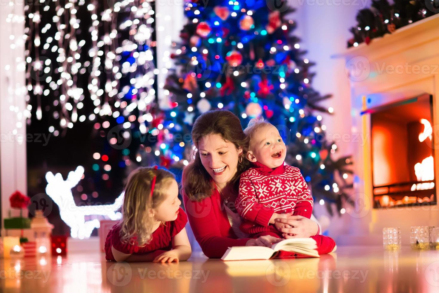 Mother and children at home on Christmas eve photo