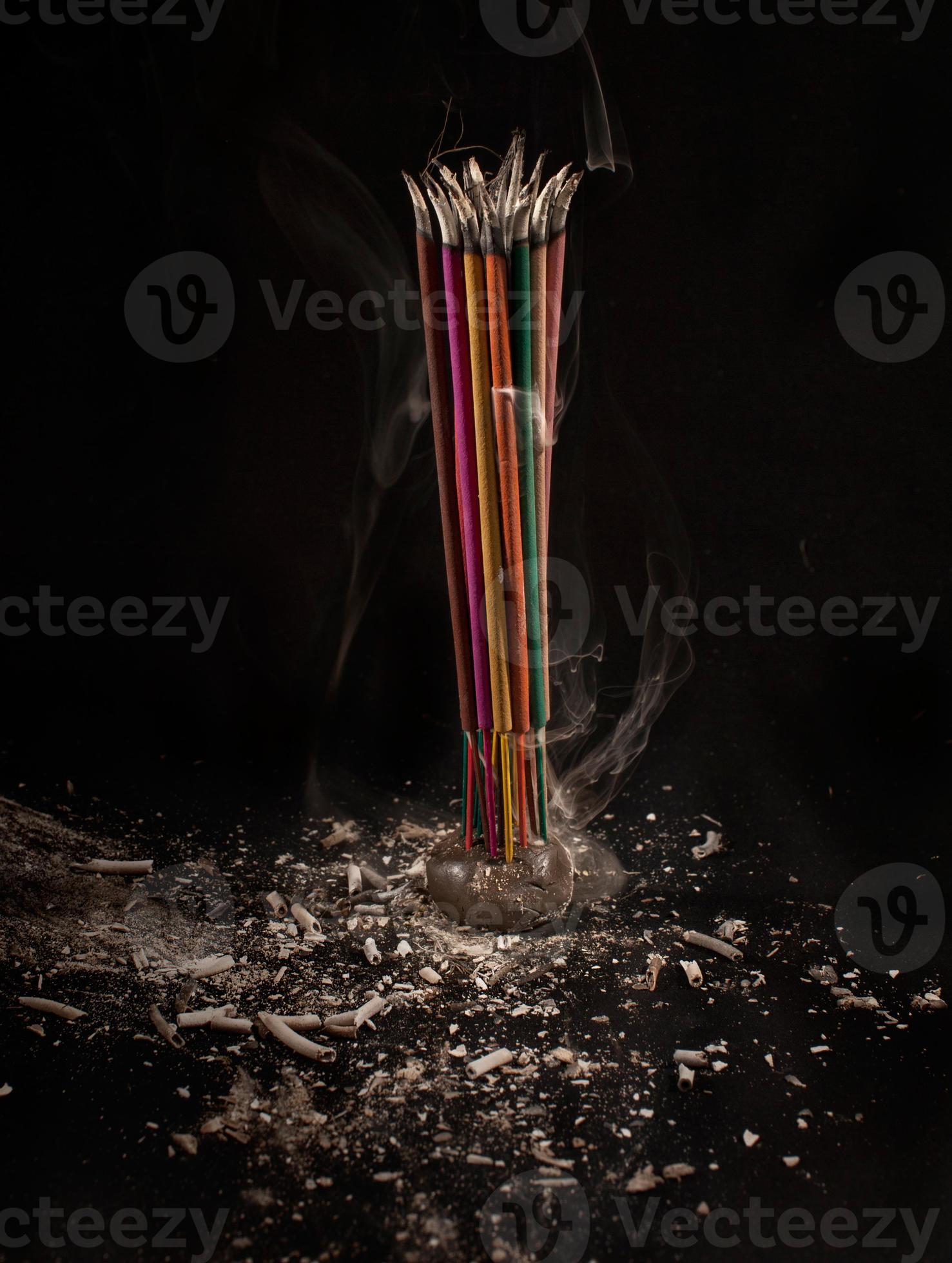 Burning incense sticks with smoke and ash on black background. 912037