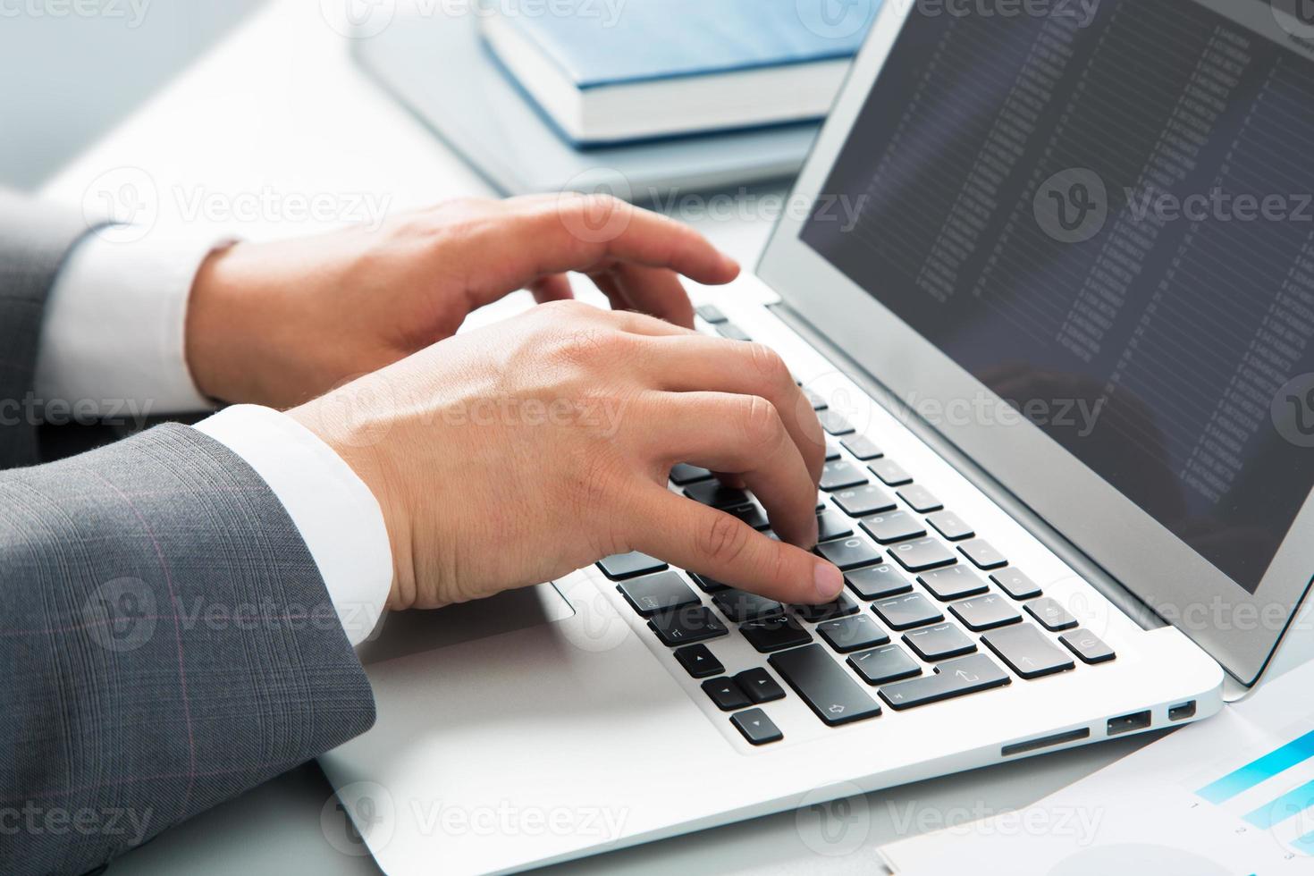 Close-up image of typing male hands photo