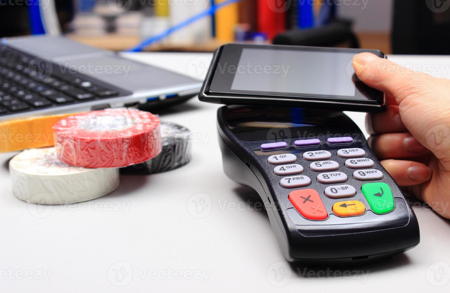 Paying with NFC technology on mobile phone photo