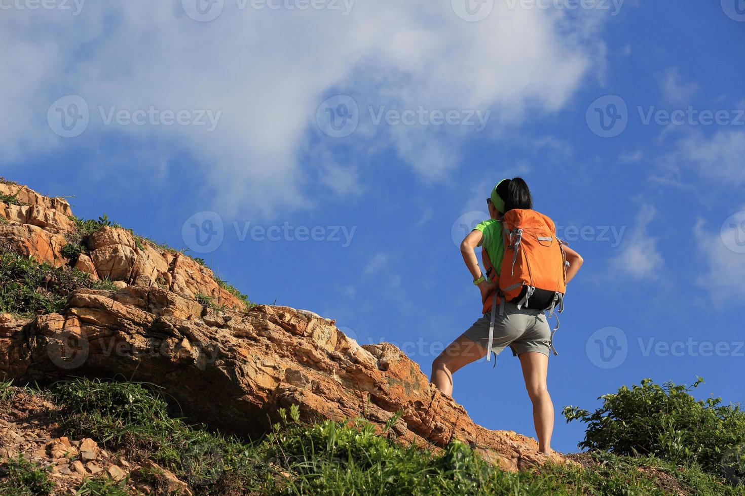 cheering young woman backpacker enjoy the view at mountain peak photo