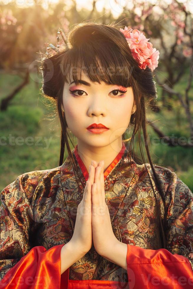 Beautiful asian woman in sakura blossom photo
