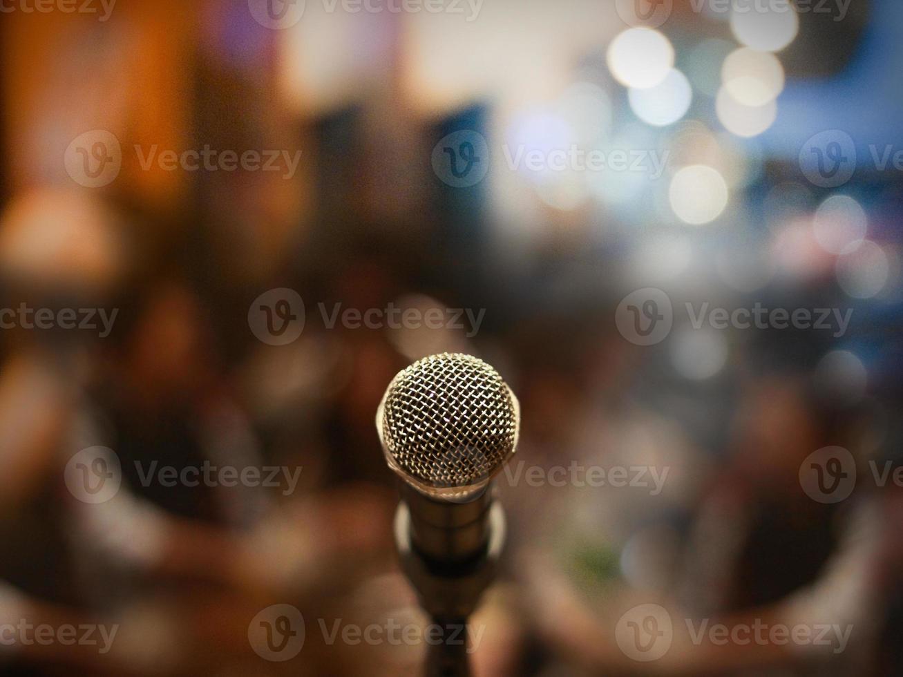 Close up of microphone in concert hall or conference room photo